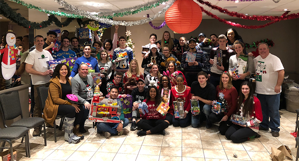 VOLLEYBALL TEAMS CONTINUE TO CHANNEL THEIR INNER SANTA CLAUS