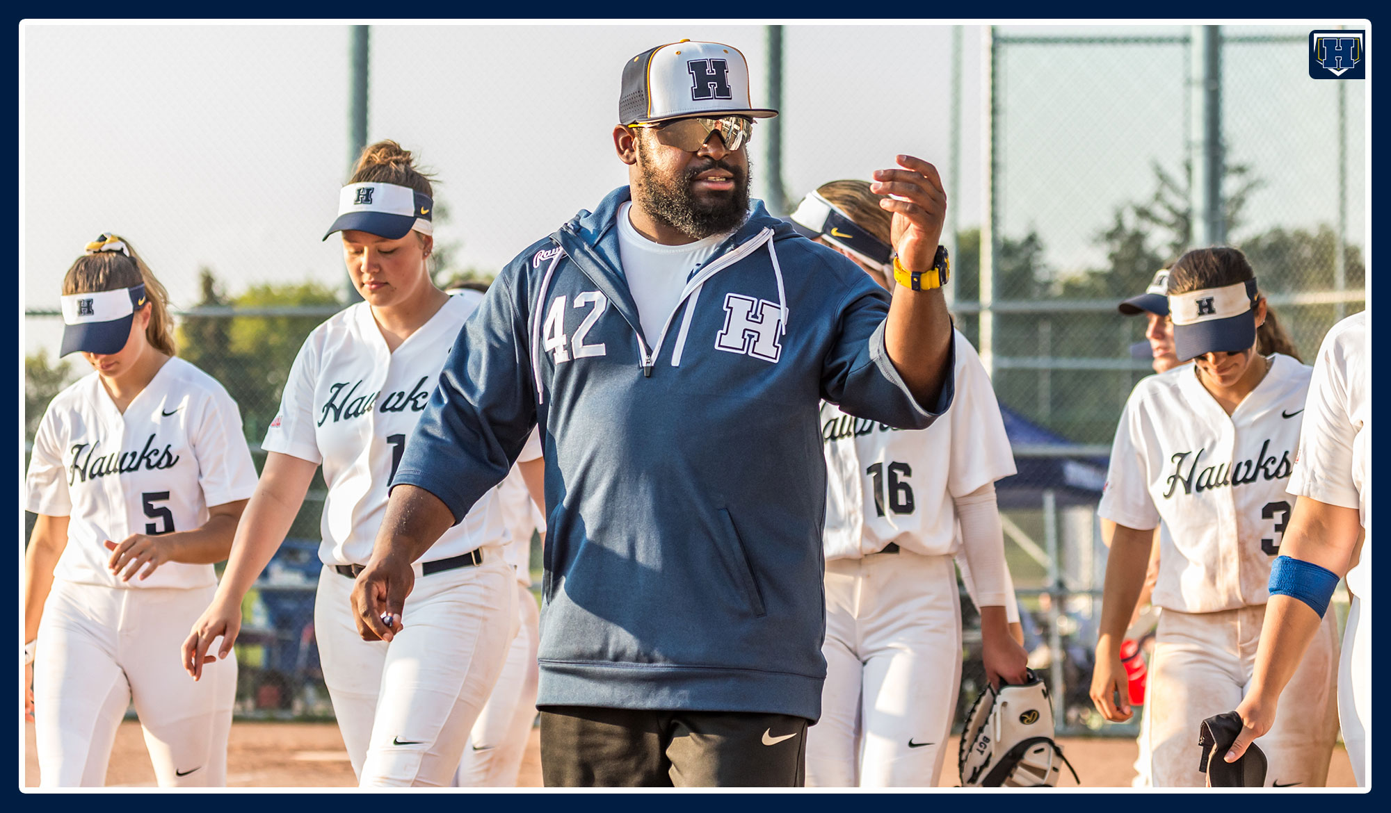 Coach Bowles rallying the troops before a softball game