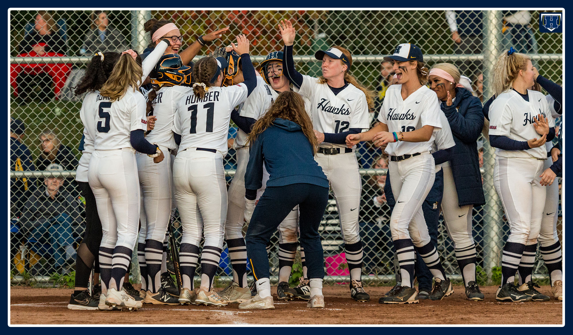 Humber softball celebrates a home run