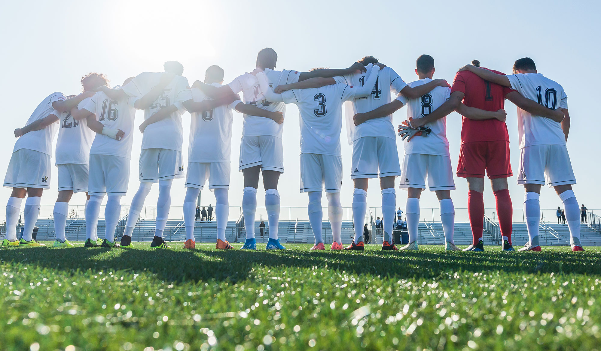 Men's soccer team lined up for the national anthem