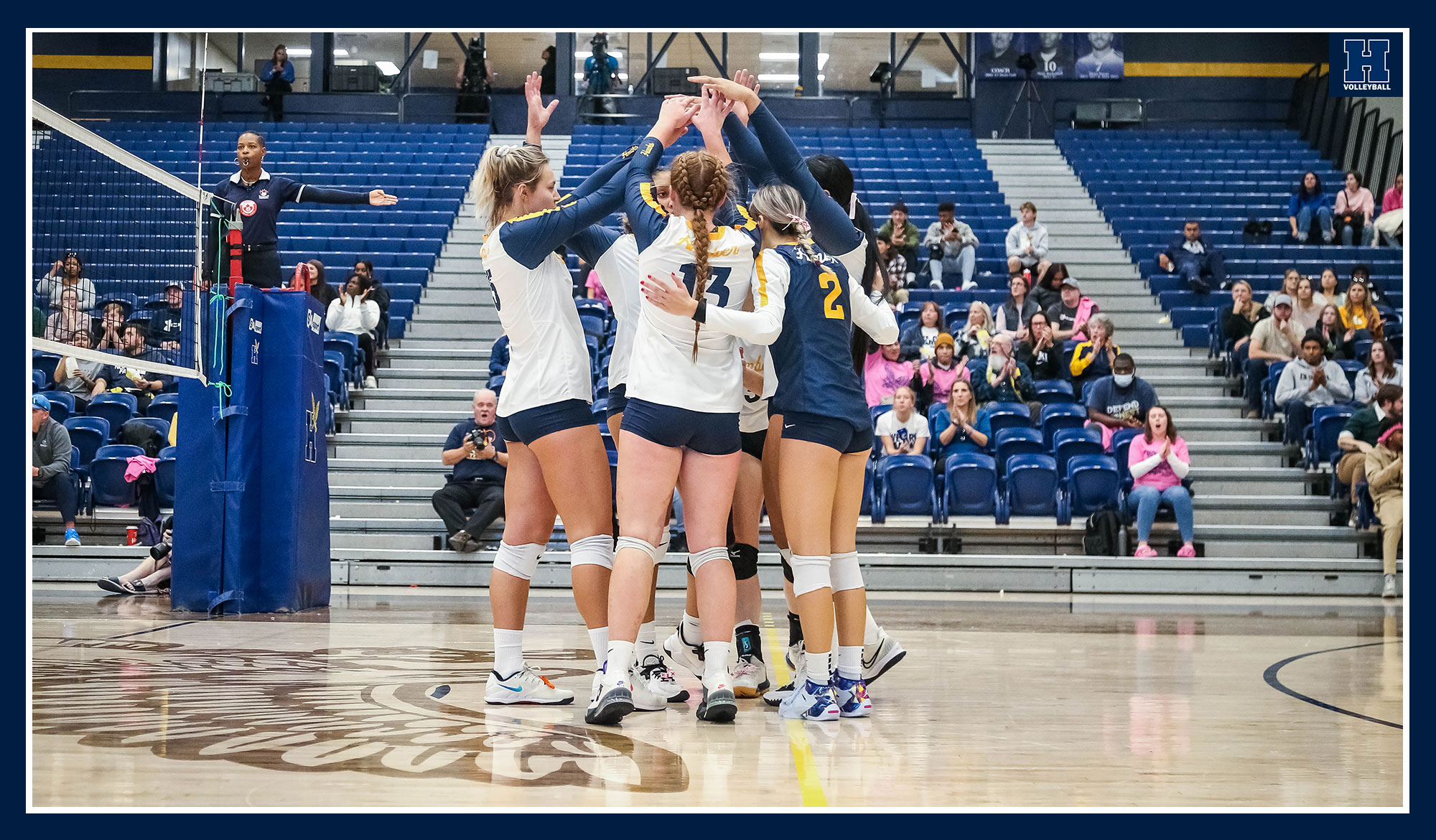 Women's volleyball celebrates a point