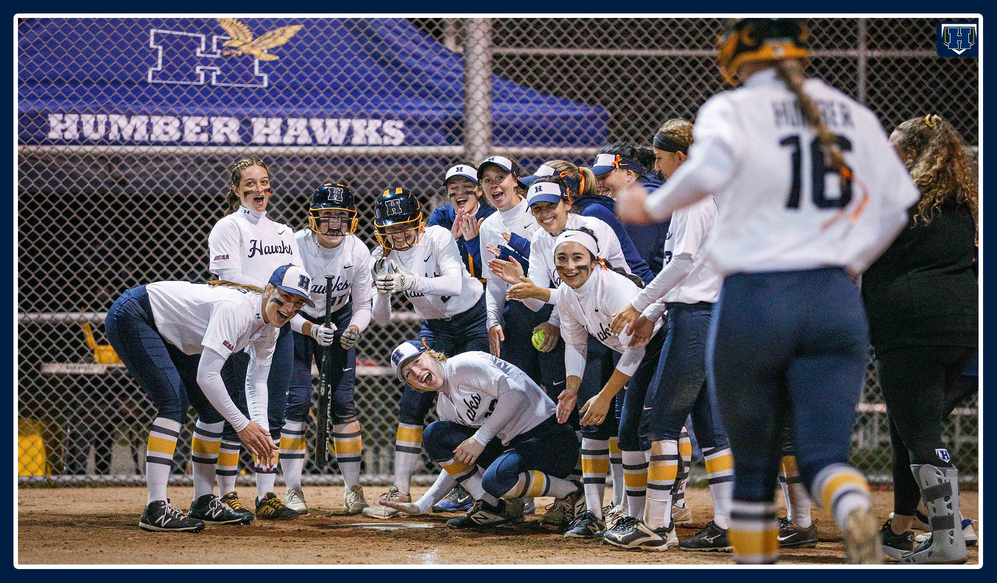 Softball team awaits at home plate for Hayley Pasma to celebrate her home run