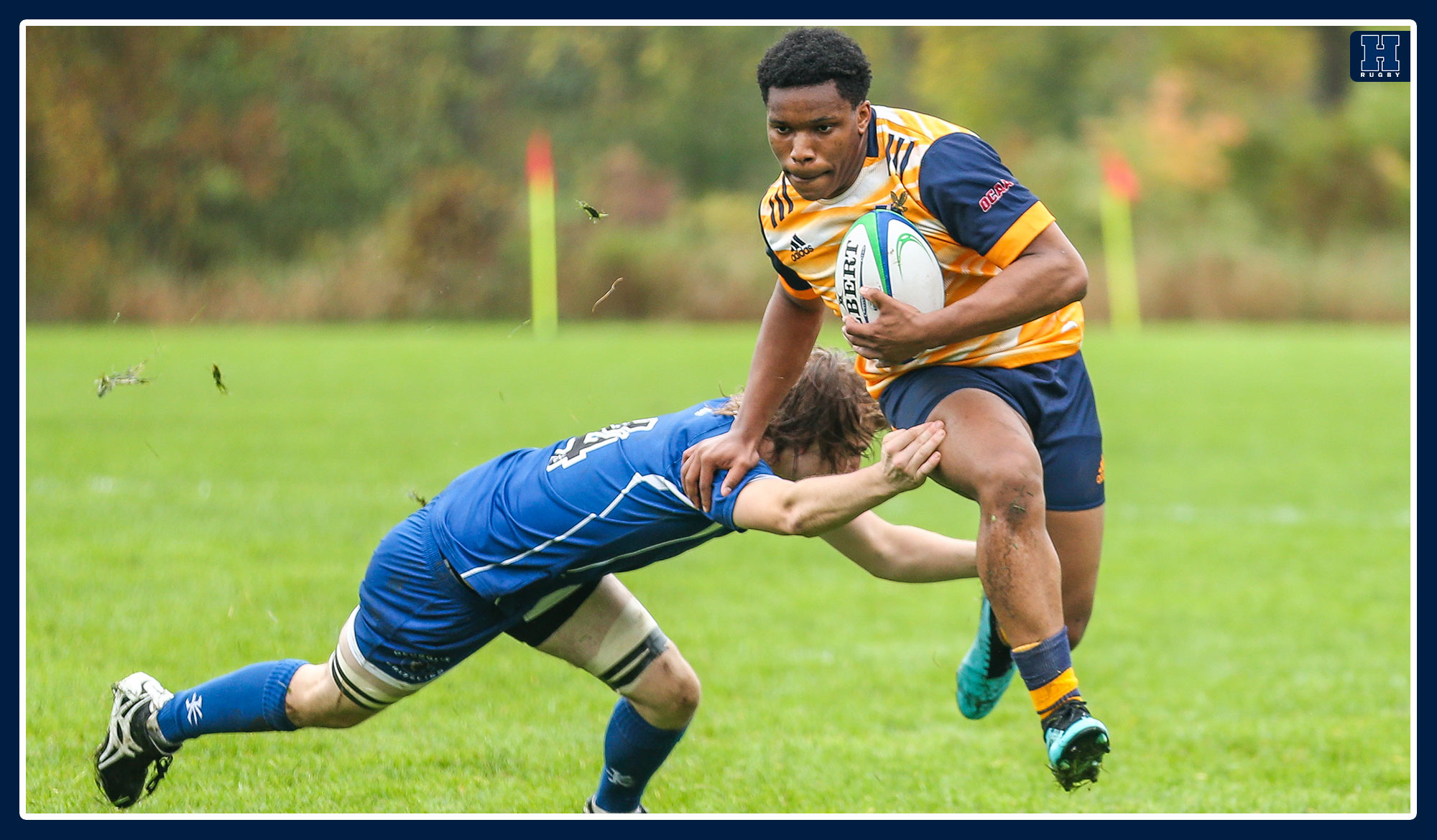 Humber rugby stiff arms a player 