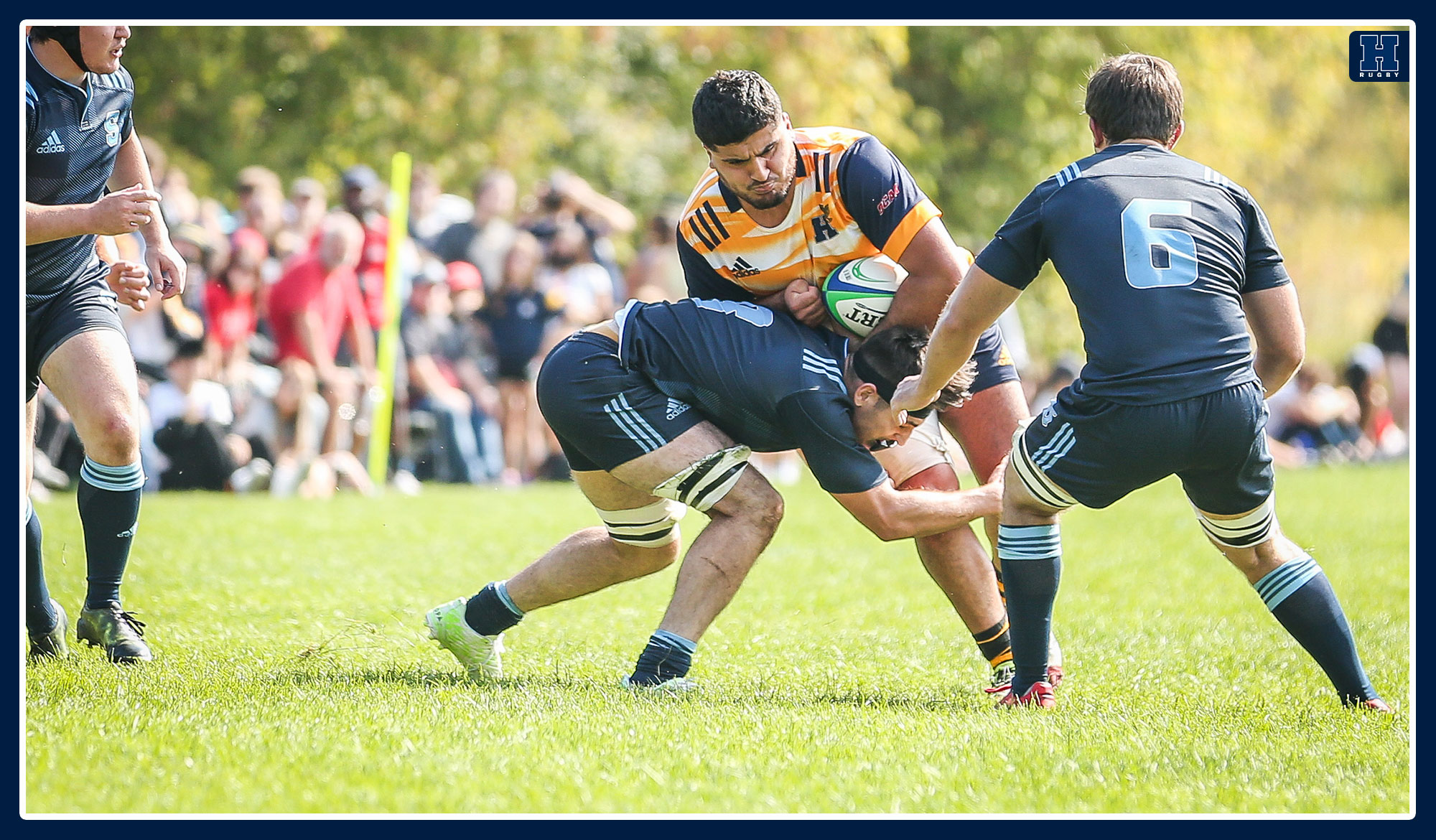 Humber player trying to run through a Sheridan defender in rugby